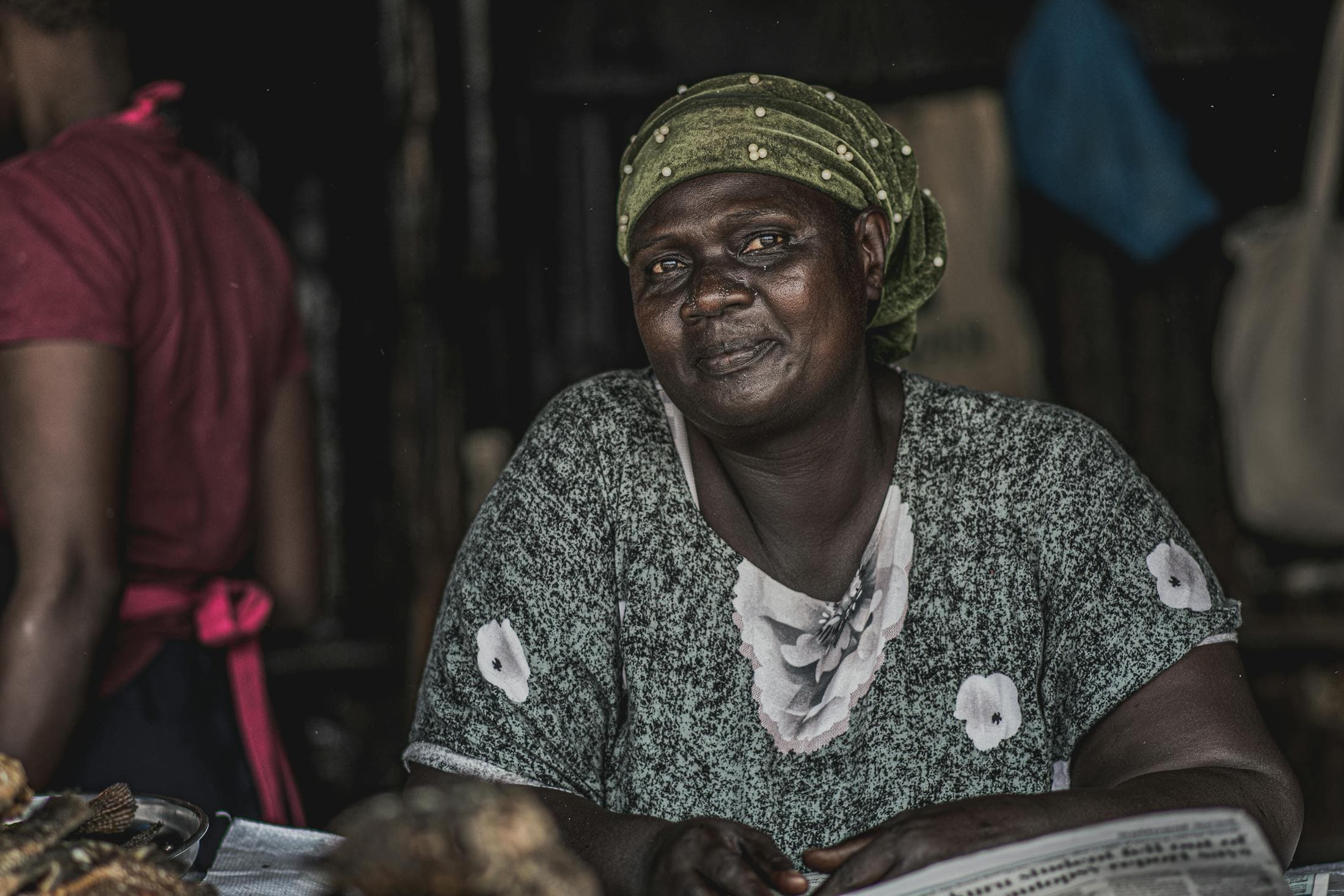 African woman entrepreneur at a market stall in a livelihoods support setting